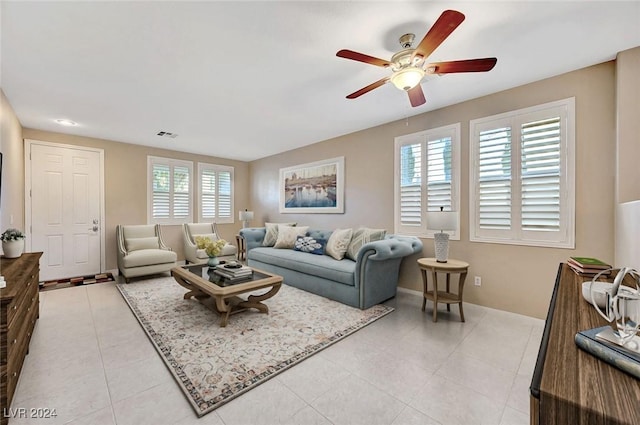 tiled living room featuring ceiling fan and a healthy amount of sunlight