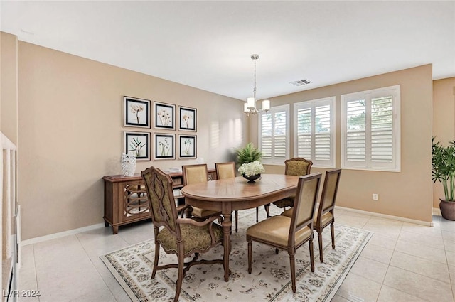 tiled dining room featuring a notable chandelier