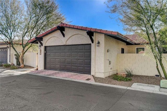 mediterranean / spanish home featuring a garage