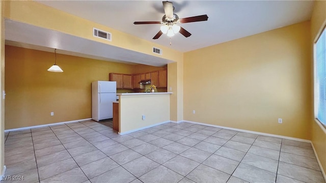 unfurnished living room with light tile patterned floors, a ceiling fan, and baseboards