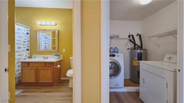 2020 Rancho Lake Dr Unit 205, Las Vegas, NV 89108 - bathroom featuring electric water heater, washing machine and dryer, wood finished floors, and toilet