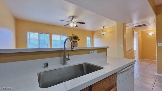 kitchen with a sink, dishwasher, light tile patterned floors, a ceiling fan, and baseboards