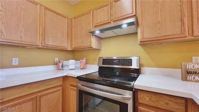 kitchen featuring stainless steel electric stove, under cabinet range hood, light countertops, and light brown cabinets