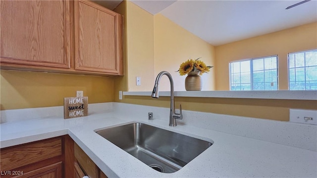 kitchen with a sink and brown cabinetry
