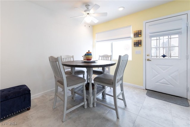 dining area featuring ceiling fan and light tile patterned floors