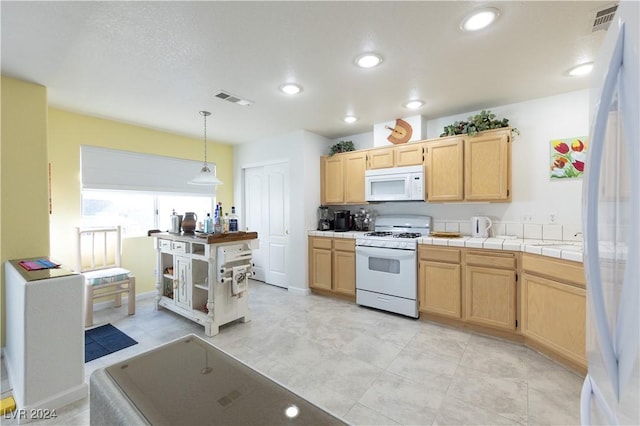 2157 Camel Mesa Dr, Laughlin, NV 89029 - kitchen with white appliances, light brown cabinets, tile counters, pendant lighting, and recessed lighting