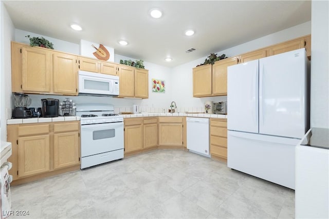 2157 Camel Mesa Dr, Laughlin, NV 89029 - kitchen featuring white appliances, light brown cabinetry, tile counters, and recessed lighting