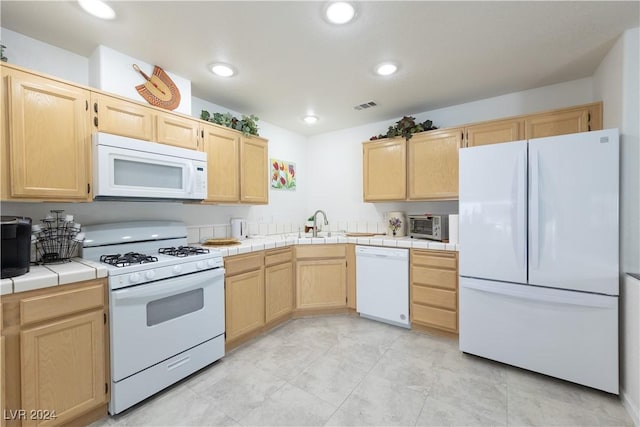 2157 Camel Mesa Dr, Laughlin, NV 89029 - kitchen with white appliances, light brown cabinetry, tile counters, and recessed lighting