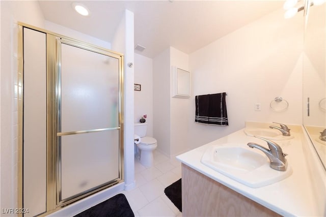 bathroom featuring tile patterned floors, toilet, vanity, and walk in shower