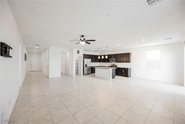 unfurnished living room with ceiling fan and light tile patterned flooring