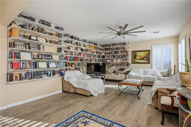 living area with ceiling fan and wood-type flooring