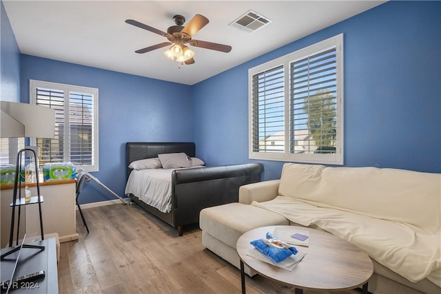 bedroom with ceiling fan and light hardwood / wood-style floors