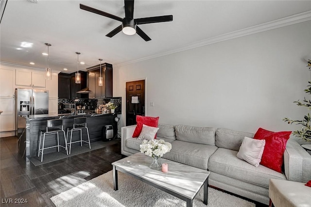 living room with ceiling fan and crown molding