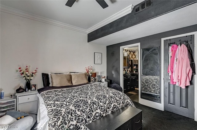 bedroom featuring dark colored carpet, connected bathroom, ceiling fan, and crown molding