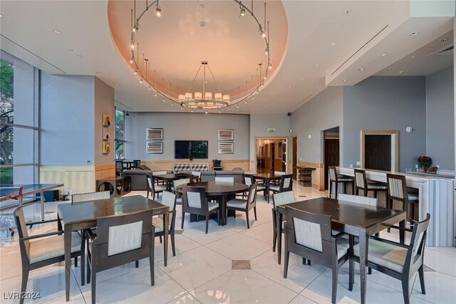 dining room with a raised ceiling and an inviting chandelier