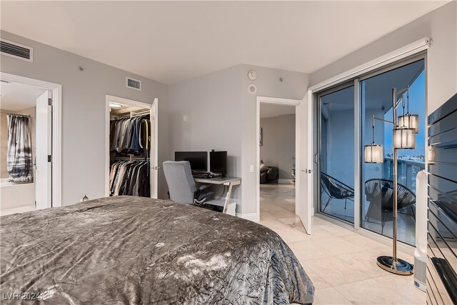 tiled bedroom with access to exterior and a closet