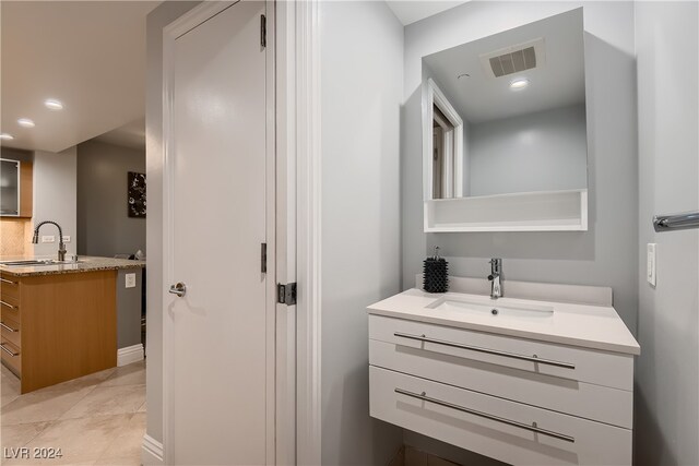 bathroom featuring tile patterned flooring and vanity