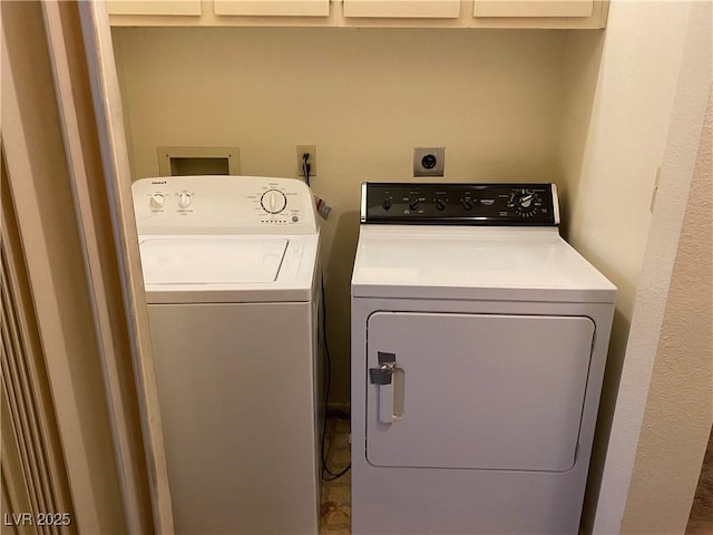 washroom with separate washer and dryer and cabinets