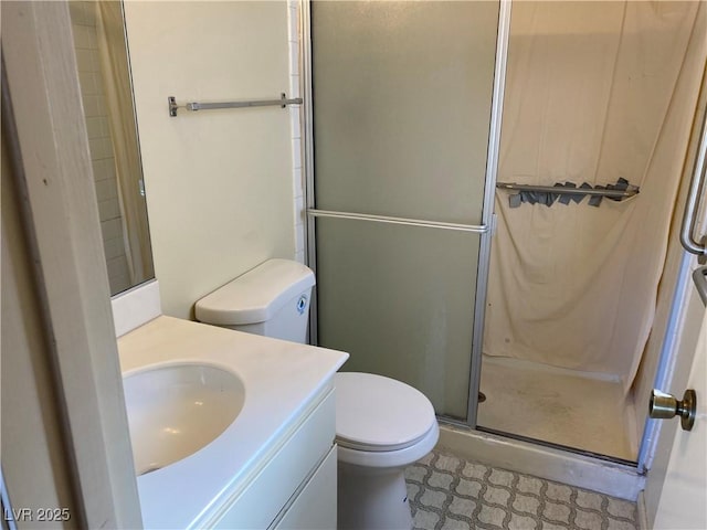 bathroom featuring vanity, an enclosed shower, and toilet