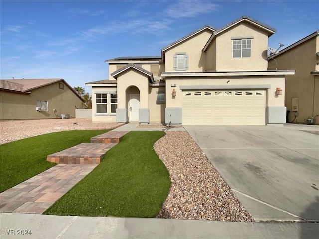 front facade featuring a garage and a front lawn