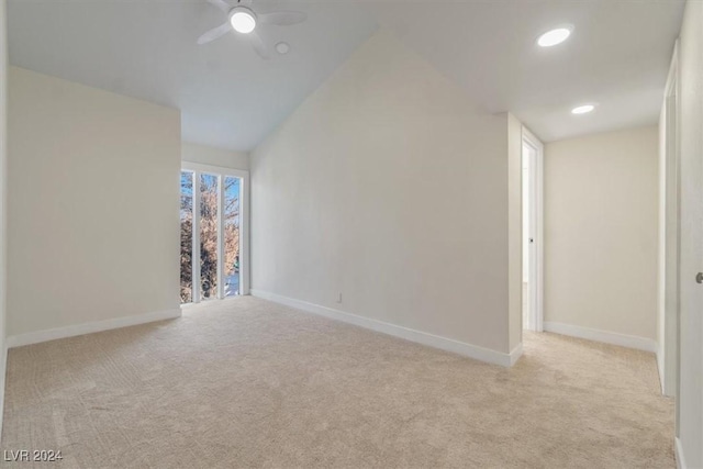 carpeted spare room featuring ceiling fan