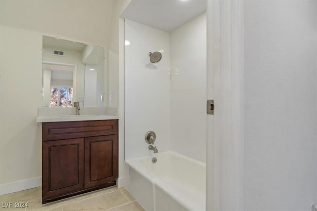 bathroom with tile patterned flooring, vanity, and tiled shower / bath combo