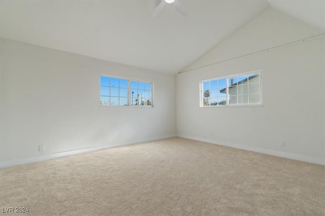 carpeted empty room featuring ceiling fan and lofted ceiling