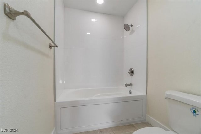 bathroom with tile patterned flooring, toilet, and washtub / shower combination