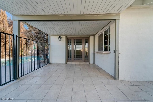 view of exterior entry featuring a fenced in pool