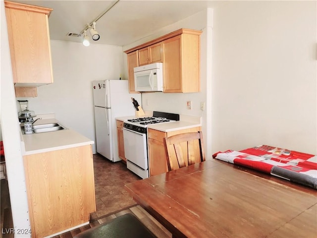 kitchen featuring white appliances, visible vents, light countertops, light brown cabinetry, and a sink