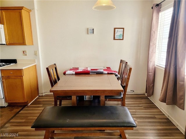 dining space with dark wood-style flooring