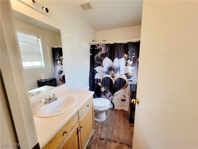 bathroom featuring toilet, vanity, visible vents, and a shower with curtain