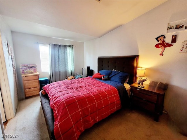 bedroom with vaulted ceiling and carpet