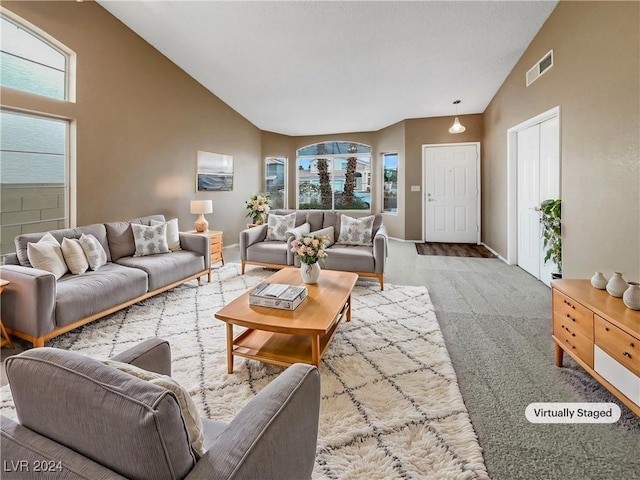 carpeted living room featuring vaulted ceiling