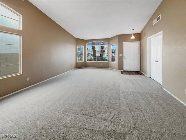 interior space with carpet flooring and vaulted ceiling