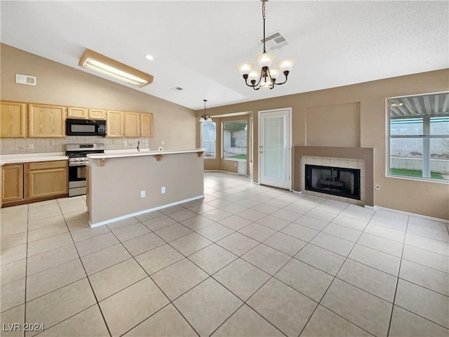 kitchen with tasteful backsplash, a notable chandelier, lofted ceiling, decorative light fixtures, and stainless steel stove