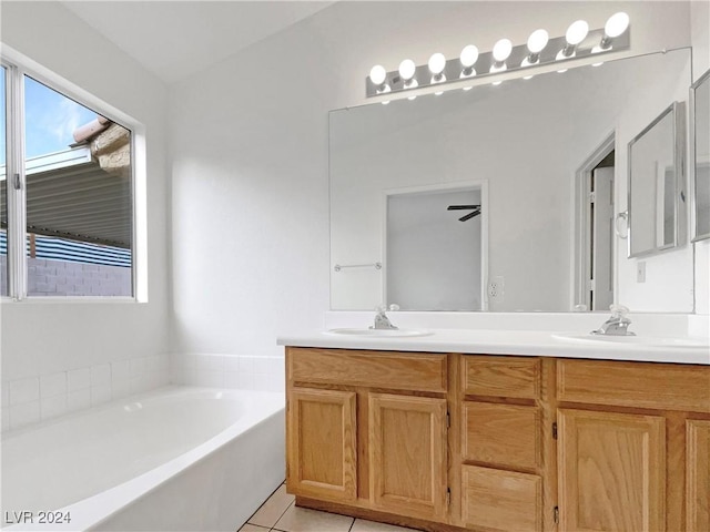 bathroom with a bathing tub, ceiling fan, tile patterned flooring, and vanity