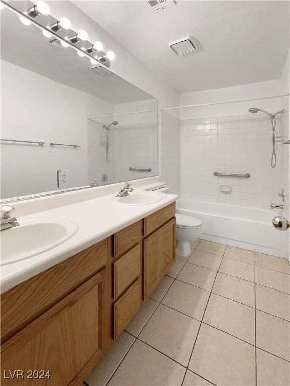 full bathroom with tile patterned flooring, vanity, toilet, and tiled shower / bath combo