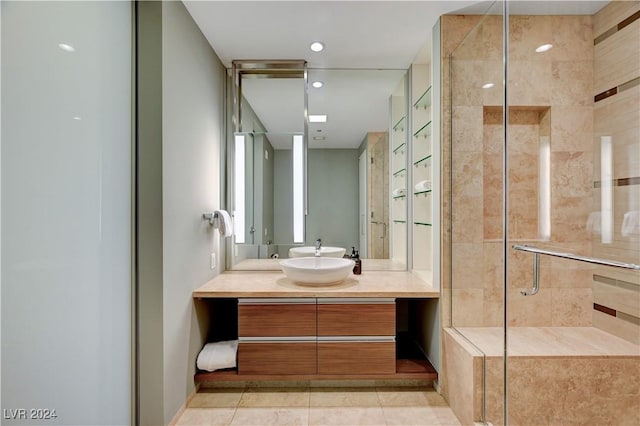 bathroom with tile patterned flooring, vanity, and an enclosed shower