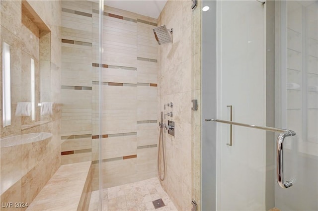 bathroom featuring a shower with shower door