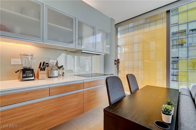 interior space featuring black electric stovetop and light tile patterned flooring