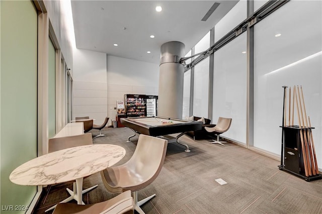 interior space featuring light carpet, pool table, and a high ceiling