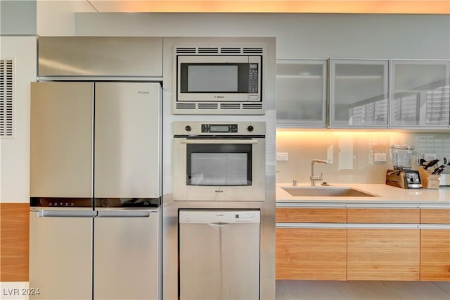 kitchen featuring tile patterned floors, sink, and appliances with stainless steel finishes