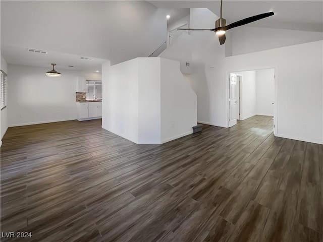 unfurnished living room featuring dark hardwood / wood-style floors, ceiling fan, and lofted ceiling