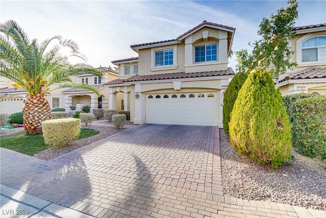 mediterranean / spanish house with a garage