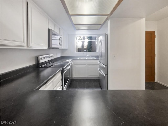 kitchen featuring white cabinets, appliances with stainless steel finishes, and sink