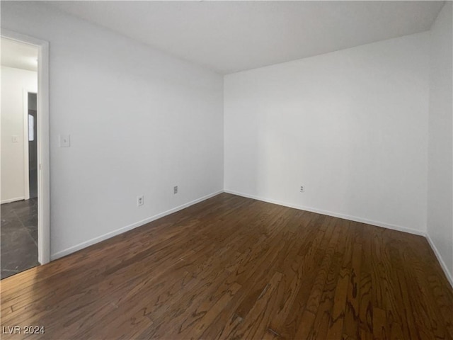 empty room featuring dark hardwood / wood-style flooring