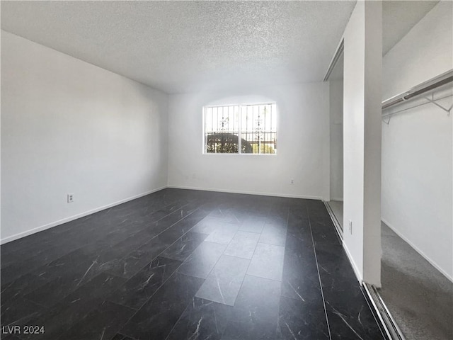 empty room with a textured ceiling