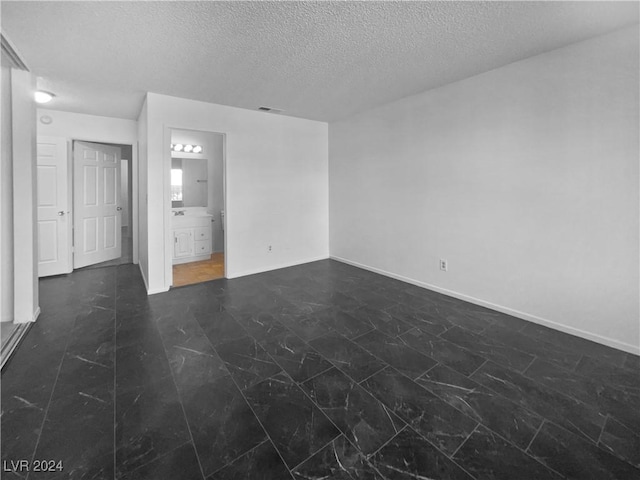 spare room with a textured ceiling