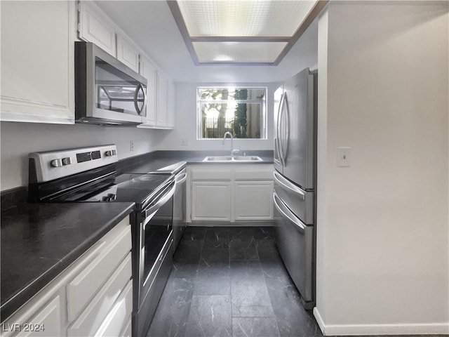 kitchen featuring white cabinets, sink, and appliances with stainless steel finishes